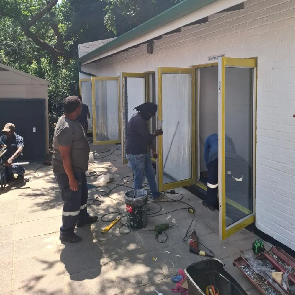 KSR Group installers on site fitting an aluminium door exterior